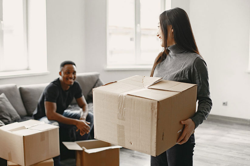 portrait-young-couple-with-cardboard-boxes-new-home-moving-house-concept